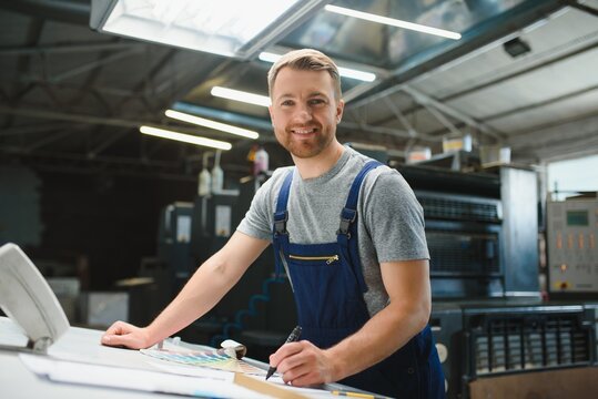 Funny portrait of typographer standing with color swatches at the printing manufacturing