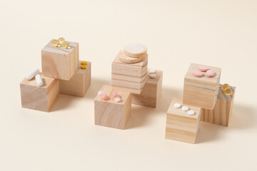 stack of pills arranged on wooden cubes