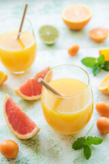 Glass of juice and citrus fruits