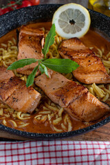 Pan fried salmon fillet with tomato cream sauce and german spaetzle noodles