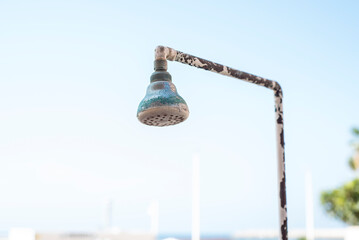 Old shower without water by the pool