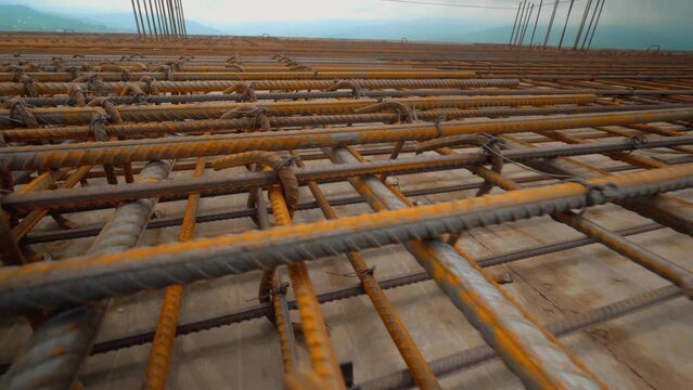 Industry background. Texture of reinforcement. Rusty reinforcement for pouring concrete. Steel reinforcing bars. Reinforcement of construction reinforcement works. Close-up of steel reinforcement.