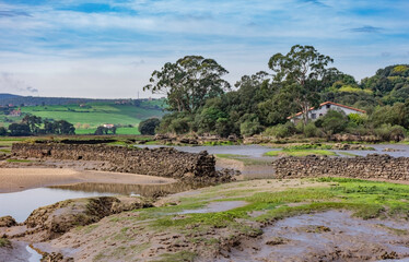 estuary landscape with low tide and blue sky with clouds - 512293508