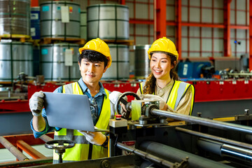 Team of Asian engineer worker inspecting inside the steel manufacturing factory while listening to manager advice on improvement of capacity and productivity concept