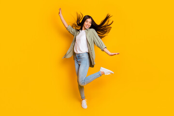 Full body portrait of positive overjoyed girl enjoy dancing clubbing isolated on yellow color background