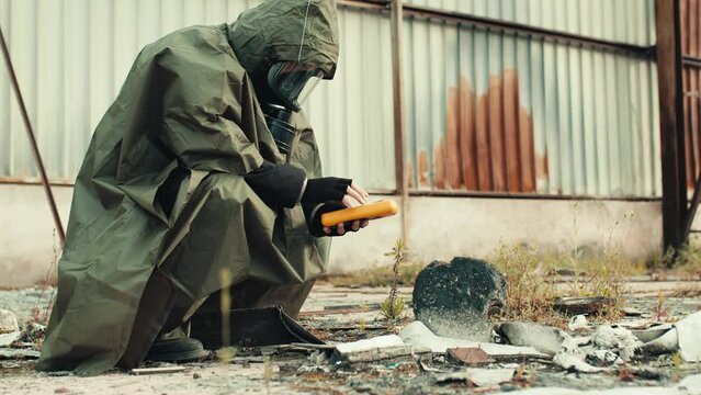 man with geiger counter near radioactive waste