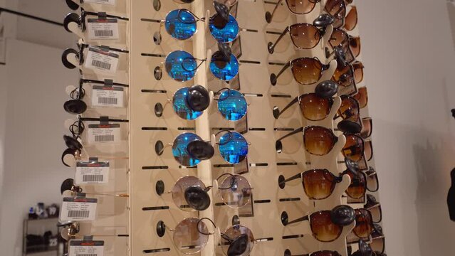 Batumi, Georgia - June 15, 2022: Rotating showcase in shopping mall with sunglasses of different styles and with different glasses. Chinese production. Market of inexpensive things.