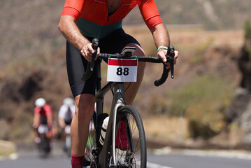 Cycling competition,cyclist athletes riding a race, climbing up a hill on a bicycle	