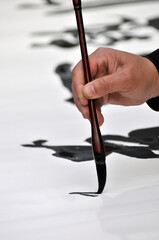 A Calligrapher hand writing chinese calligraphy