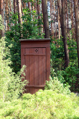 Old wooden toilet standing outside in the forest