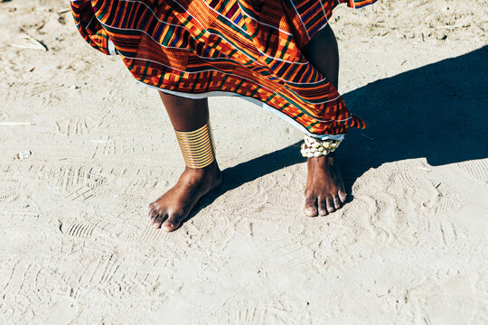 Crop black woman in traditional African apparel