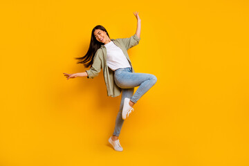 Fototapeta na wymiar Full length portrait of overjoyed gorgeous lady enjoy dancing partying isolated on yellow color background
