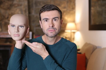 Man holding model head with the perfect masculine face 