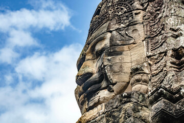 Fototapeta premium Sculpture of a smiling person's face on a large sandstone at Bayon Angkor Thom Temple, Siem Reap, Cambodia.
