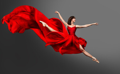 Ballerina Dance. Ballet Dancer in Red Dress jumping Split. Woman in Ballerina Shoes dancing in Silk Gown flying on Wind over Gray Studio Background - obrazy, fototapety, plakaty