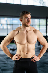 Fototapeta na wymiar Athletic man posing hardcore in the gym