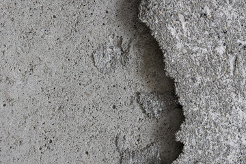 Texture of an old cracked concrete wall. Grungy gray concrete surface with shadow. Perfect for background and design. Close-up. Copy space. High resolution.