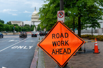 Close Up View of Construction Sign With US Capitol in the Background with Storm Clouds in the SKy