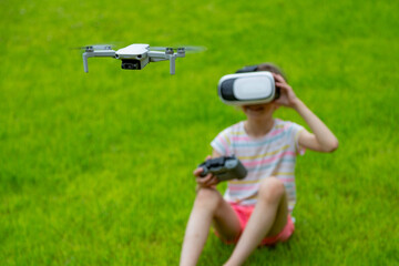 Little girl with virtual reality vr headset is operating drone with natural background. Technology concept