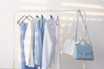 female white and blue capsule summer wardrobe in  white room