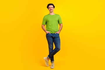 Fototapeta na wymiar Full size portrait of confident young person put arms pockets posing isolated on yellow color background