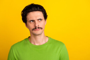 Fototapeta premium Photo of focused concentrated person calm face look interested empty space isolated on yellow color background