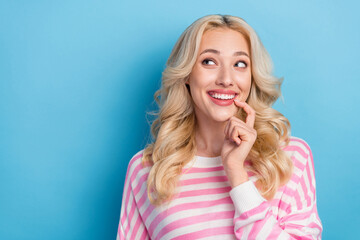 Fototapeta premium Photo of impressed young blond hairdo lady look promo wear striped shirt isolated on blue color background