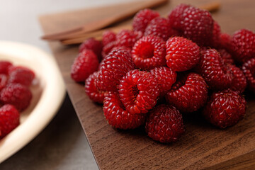 Small, red, sour and sweet fruit raspberries