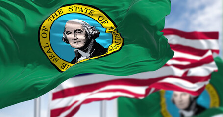 The Washington state flag waving along with the national flag of the United States of America