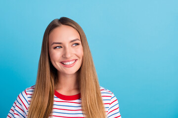 Portrait of adorable pretty person toothy smile look interested empty space isolated on blue color...