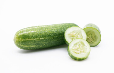 whole cucumber with some pieces isolated on white background.fresh vegetable for healthy diet