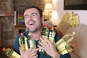 Man holding many cooking oil bottles with satisfaction