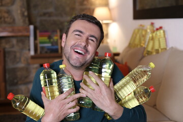 Man holding many cooking oil bottles with satisfaction 