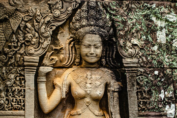 A sandstone sculpture of Apsara with a beautiful face and body at Bayon Angkor Thom Temple, Siem...