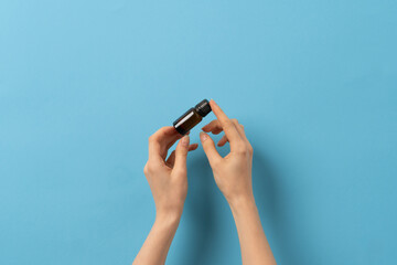 Female hand holding a jar of medication liquid