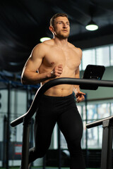 Fototapeta na wymiar Male athlete running on a treadmill