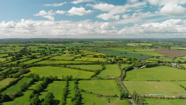 A slow aerial flight over the patchwork of fields in Wiltshire UK