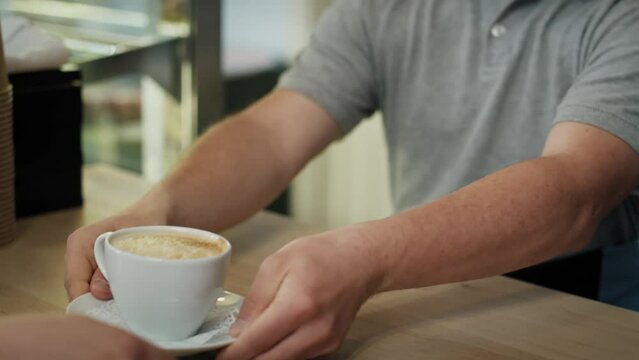 Caucasian man with down syndrome walking and carrying a cup of coffee. Shot with RED helium camera in 8K.  