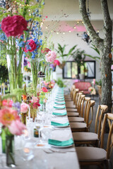 Fototapeta na wymiar Fairytale wedding table setting with a lot of flowers