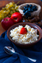 Cottage cheese or curd cheese in bowl with strawberry. Rich in Protein and Calcium healthy dairy product, low fat soft white cheese