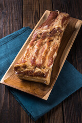 Pork belly on a wooden cutting board. Rustic old wooden table top.