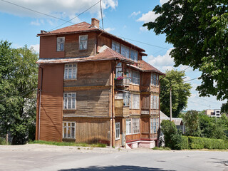 Old multi-storey wooden house on the outskirts of the city.