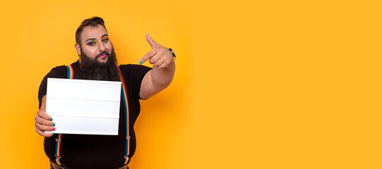 Big bearded gay man holding a pointing to a lightbox