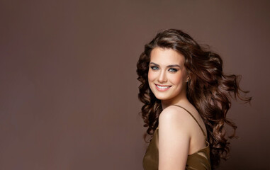 Portrait of perfect beautiful young model woman with long brown hair with wind smiling, fashion...
