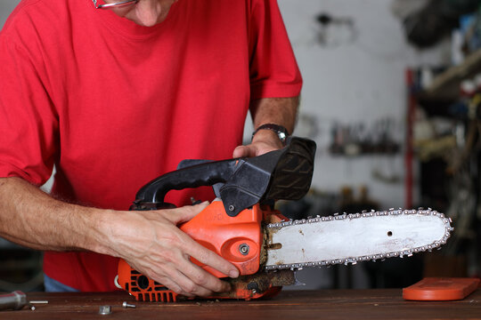 cleaning of the small chainsaw by a person