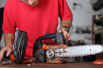 cleaning of the small chainsaw by a person