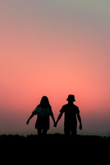 Fototapeta na wymiar silhouette of a romantic couple enjoying beautiful sunset on outdoors.