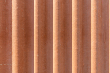 Corrugated red asbestos roof.A fragment of a roof background.