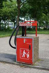 A big red vacuum cleaner for vehicles on a public parking lot near a gas station in Oss (the Netherlands). The sign says "vacuum cleaner".