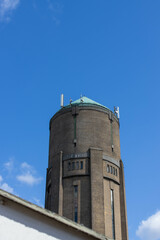A 48 meter high water tower. Build in 1935 with bricks and a copper roof. The tower is located in Oss, the Netherlands. With on the ground floor a small supermarket. It's not used for water anymore.